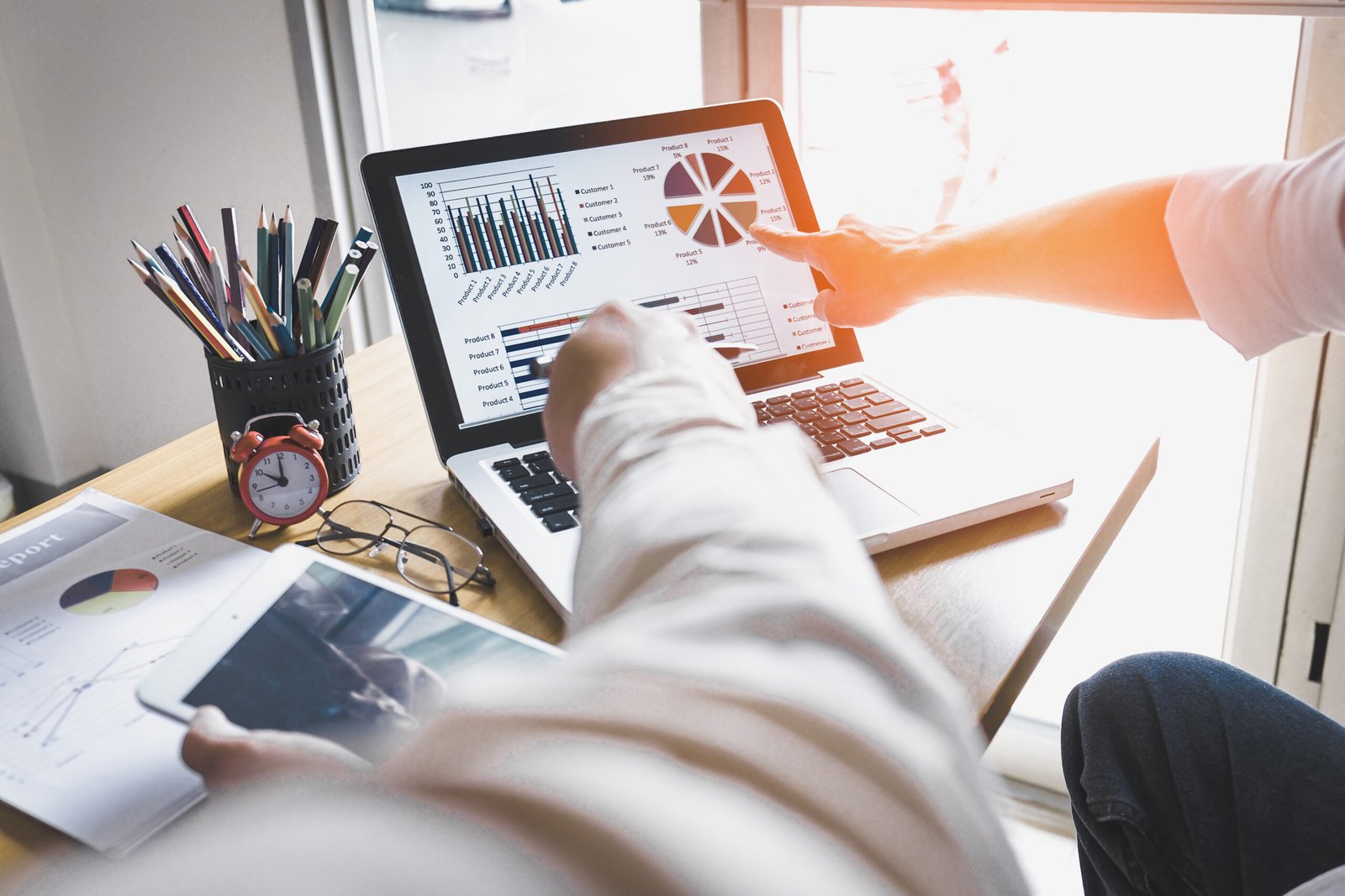 Business person analyzing financial statistics displayed on the